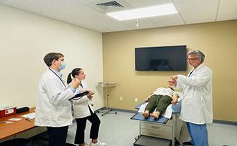 Doctor with medical students and standardized patient